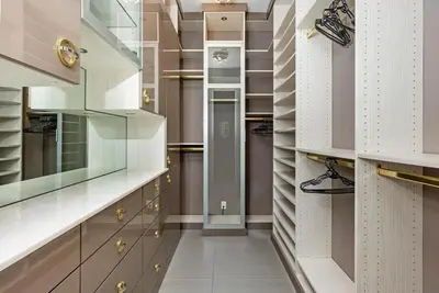 a walk in closet with white and brown cabinets at VILLA ST-BARTH Waterfront w htd pool by VIAC in Fort Lauderdale