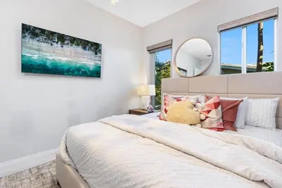 a bedroom with a bed with a teddy bear sitting on it at VILLA ST-BARTH Waterfront w htd pool by VIAC in Fort Lauderdale
