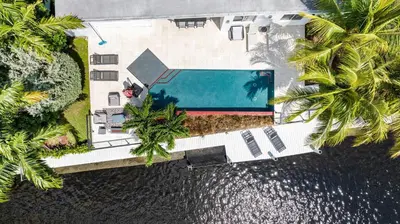 an overhead view of a swimming pool with palm trees at VILLA ST-BARTH Waterfront w htd pool by VIAC in Fort Lauderdale