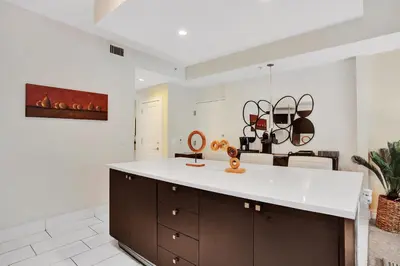 a kitchen with a white counter top and a table at Villa Vista-2 Story w 3Bdrms & Golf View in Miami