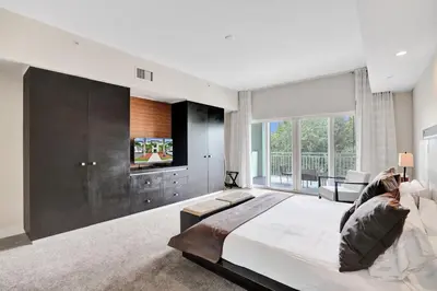a bedroom with a large bed and a flat screen tv at Villa Vista-2 Story w 3Bdrms & Golf View in Miami