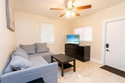 a living room with a couch and a ceiling fan at First-Class 5BR Villa in Hollywood Lakes in Hollywood