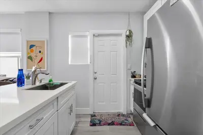 a white kitchen with a sink and a refrigerator at Massage Chair - Backyard - 5 min 2 DT Calle 8 Brickell in Miami