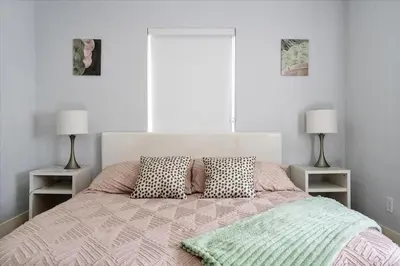 a bedroom with a large bed with two lamps at Massage Chair - Backyard - 5 min 2 DT Calle 8 Brickell in Miami