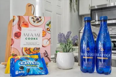 a counter with two bottles of water and a box of food at Massage Chair - Backyard - 5 min 2 DT Calle 8 Brickell in Miami