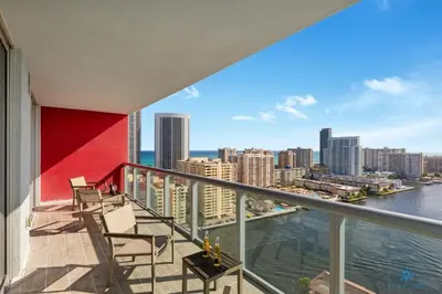 a balcony with chairs and a view of the city at Infinite View - Balcony - Pool - Gym - Near Beach in Hallandale Beach