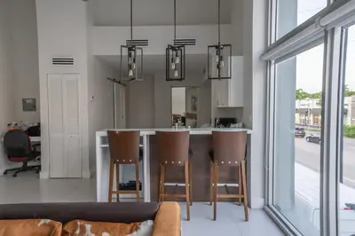 a kitchen with a couch and a bar with chairs at The Biscayne Hotel in Miami