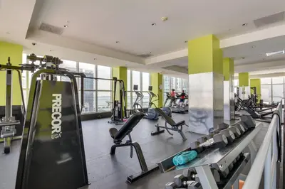 a gym with treadmills and machines in a building at Trendy Downtown Miami Studio Pools, Views and More! in Miami