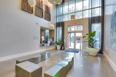 a lobby with benches and tables in a building at Trendy Downtown Miami Studio Pools, Views and More! in Miami