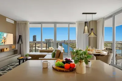 a living room with a table with fruit on it at Awesome Bayview - Pools - Gym in Hollywood