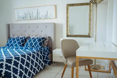 a bedroom with a bed and a desk and a mirror at YOUR VACATION HOME! NEAR THE BEACH in Miami Beach
