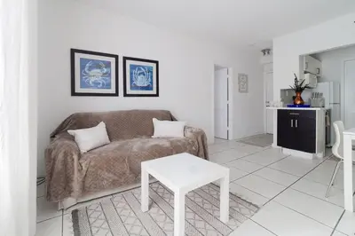 a living room with a couch and a table at BEACH VIBES in Miami Beach