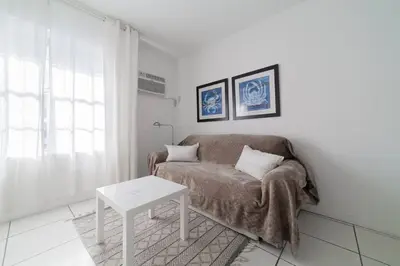 a living room with a couch and a table at BEACH VIBES in Miami Beach