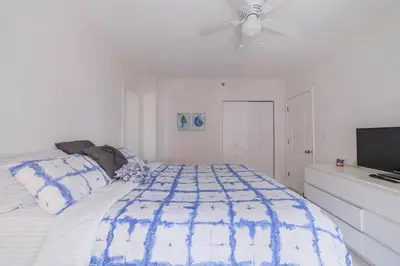 a bedroom with a bed and a ceiling fan at OCEAN & SAND ONLY 1 MINUTE WALK! in Miami Beach