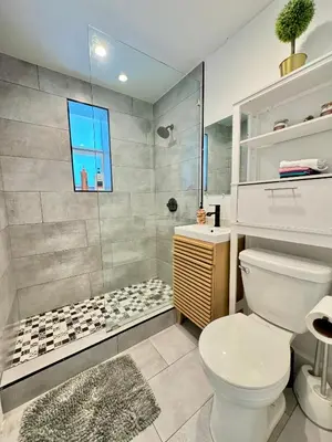 a bathroom with a white toilet and a shower at HOT TUB HOUSE ON GOLF COURSE! 10 MINs TO THE BEACH in Miami