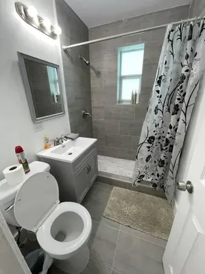a bathroom with a toilet and a sink and a shower at HOUSE WITH POOL, 10 MINS DRIVE TO THE BEACH! in Miami Shores