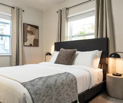 a bedroom with a large bed and two windows at La Vie Boheme 1 - Relaxing Retreat w Parking in Miami