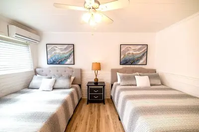 two beds in a room with a ceiling fan at Luxury Miami Village w/Pool+Grill+MiniGolf in Miami