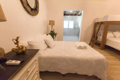 a bedroom with a white bed and a mirror at Luxury Miami Village w/Pool+Grill+MiniGolf in Miami