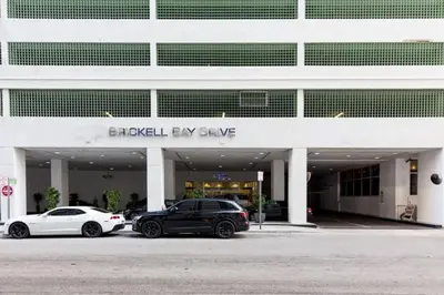 two cars parked in front of a building at One of Brickell Bays Best with Pool and Gym Access in Miami