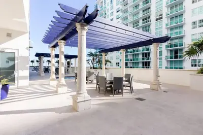 a pavilion with a table and chairs in a building at One of Brickell Bays Best with Pool and Gym Access in Miami