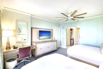 a bedroom with a bed and a desk and a tv at Stunning Studio Apartment Located at the Ritz Carlton-Key Biscayne in Miami