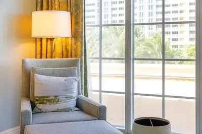 a chair in a room with a large window at Breathtaking 2 Bedroom Condo Placed at Ritz Carlton-Key Biscayne in Miami