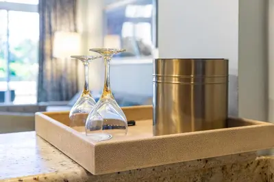 two champagne glasses on a wooden tray on a table at Breathtaking 2 Bedroom Condo Placed at Ritz Carlton-Key Biscayne in Miami