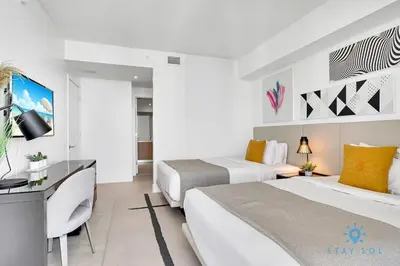 a hotel room with two beds and a television at Brand New 2Br Insane Ocean View and Amenities in Hollywood