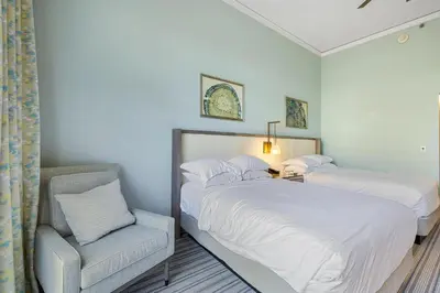 a bedroom with two twin beds and a chair at Charming 5 Star Condo Unit Situated at Ritz Carlton-Key Biscayne in Miami