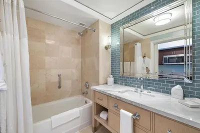 a bathroom with a tub and a sink and a mirror at Charming 5 Star Condo Unit Situated at Ritz Carlton-Key Biscayne in Miami