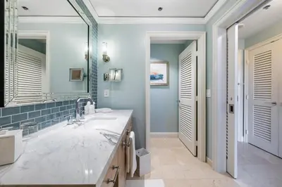 a bathroom with a sink and a large mirror at Charming 5 Star Condo Unit Situated at Ritz Carlton-Key Biscayne in Miami
