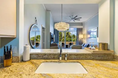 a kitchen with a sink and a living room at Unique 1BR Suite Condo Located at Ritz Carlton-Key Biscayne in Miami
