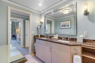 a bathroom with two sinks and a large mirror at Unique 1BR Suite Condo Located at Ritz Carlton-Key Biscayne in Miami