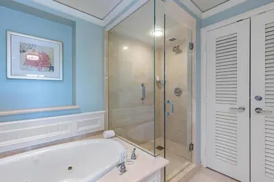 a bathroom with a tub and a glass shower at Unique 1BR Suite Condo Located at Ritz Carlton-Key Biscayne in Miami