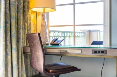 a desk with a lamp and a chair in a hotel room at Unique 1BR Suite Condo Located at Ritz Carlton-Key Biscayne in Miami