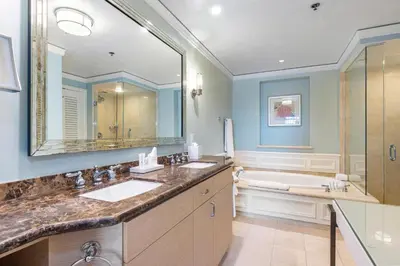 a bathroom with two sinks and a large mirror at Unique 1BR Suite Condo Located at Ritz Carlton-Key Biscayne in Miami