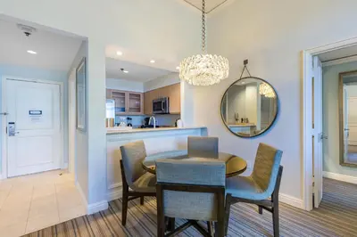 a dining room with a table and chairs and a mirror at Unique 1BR Suite Condo Located at Ritz Carlton-Key Biscayne in Miami