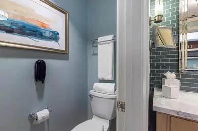 a bathroom with a toilet and a painting on the wall at Lovely Deluxe Unit Located at Ritz Carlton - Key Biscayne! in Miami