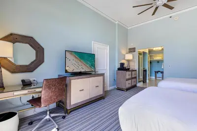 a hotel room with a bed and a desk with a television at Lovely Deluxe Unit Located at Ritz Carlton - Key Biscayne! in Miami