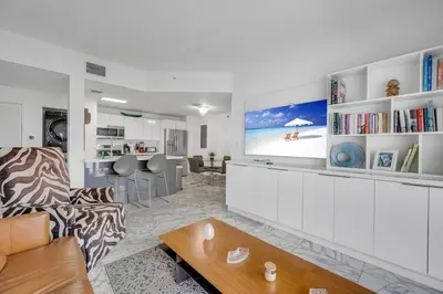 a living room with a couch and a tv on a wall at Subtle 2 Bed in Edgewater near Downtown With Free Parking in Miami