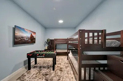 a room with two bunk beds with a table in it at Luxury Duplex in Heart of Fort Lauderdale Near The Beach in Fort Lauderdale
