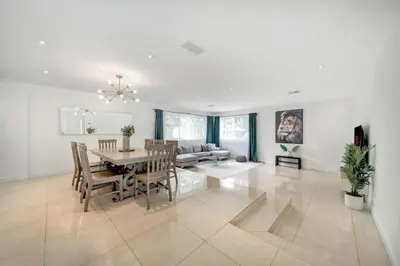 a dining room and living room with a table and chairs at Luxury 7BR Villa Vizcaya Pool Sauna Gym Golf in Miami