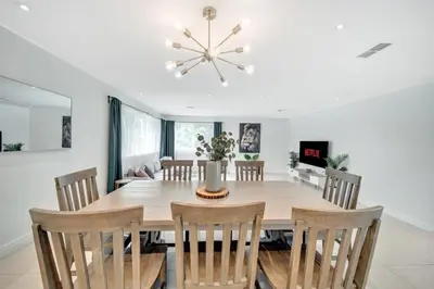 a dining room with a table and chairs at Luxury 7BR Villa Vizcaya Pool Sauna Gym Golf in Miami