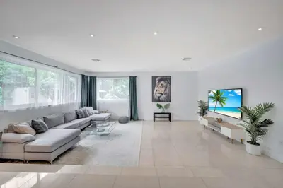 a white living room with a couch and a table at Luxury 7BR Villa Vizcaya Pool Sauna Gym Golf in Miami