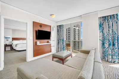 a living room with a couch and a tv at TRUMP INTERNATIONAL BEACH RESORT 2 BEDROOM APARTMENT 1600 Sqf OCEAN FRONT in Miami Beach