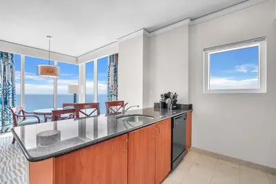 a kitchen with a sink and a table with chairs at TRUMP INTERNATIONAL BEACH RESORT 2 BEDROOM APARTMENT 1600 Sqf OCEAN FRONT in Miami Beach