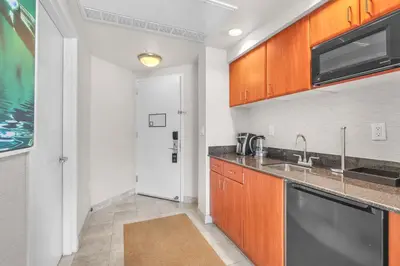 a kitchen with wooden cabinets and a sink at TRUMP INTERNATIONAL BEACH RESORT 2 BEDROOM APARTMENT 1600 Sqf OCEAN FRONT in Miami Beach