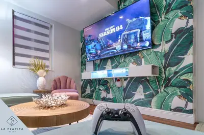 a living room with a tv on a wall at La Playita 4-BR Heated Pool Miami 16 Guests in Miami