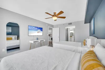 a bedroom with two beds and a ceiling fan at Ocean front private unit in Miami